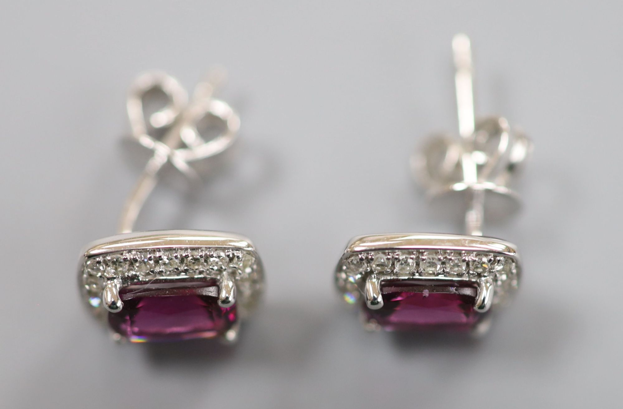 A pair of white metal (stamped 375), garnet and diamond set rectangular cluster ear studs, 8mm, gross 2 grams.